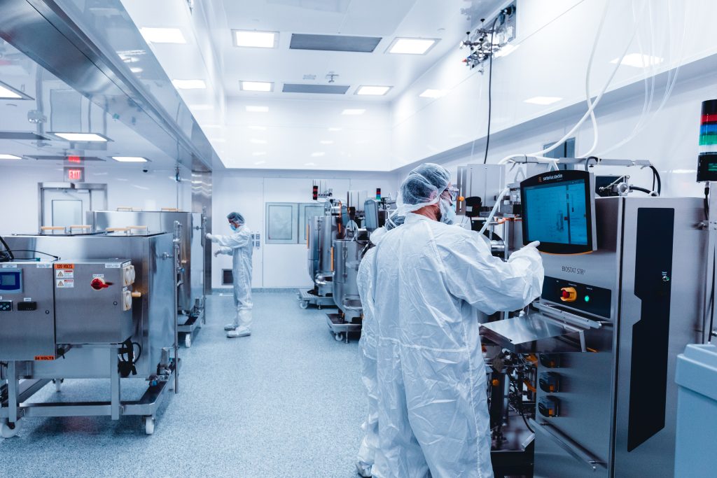 Multiple people working in a cleanroom