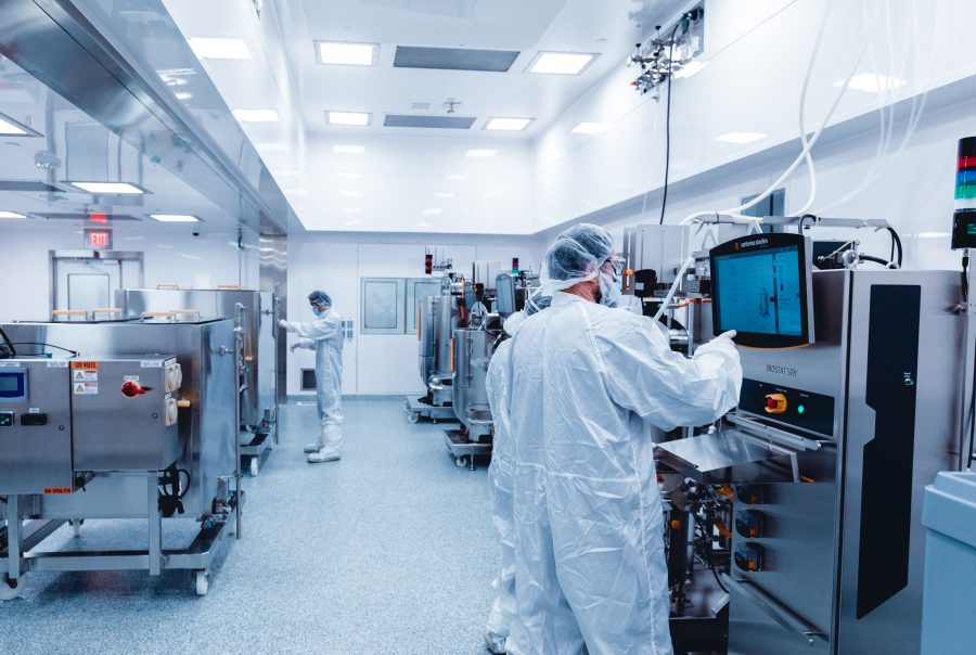 Multiple people working in a cleanroom