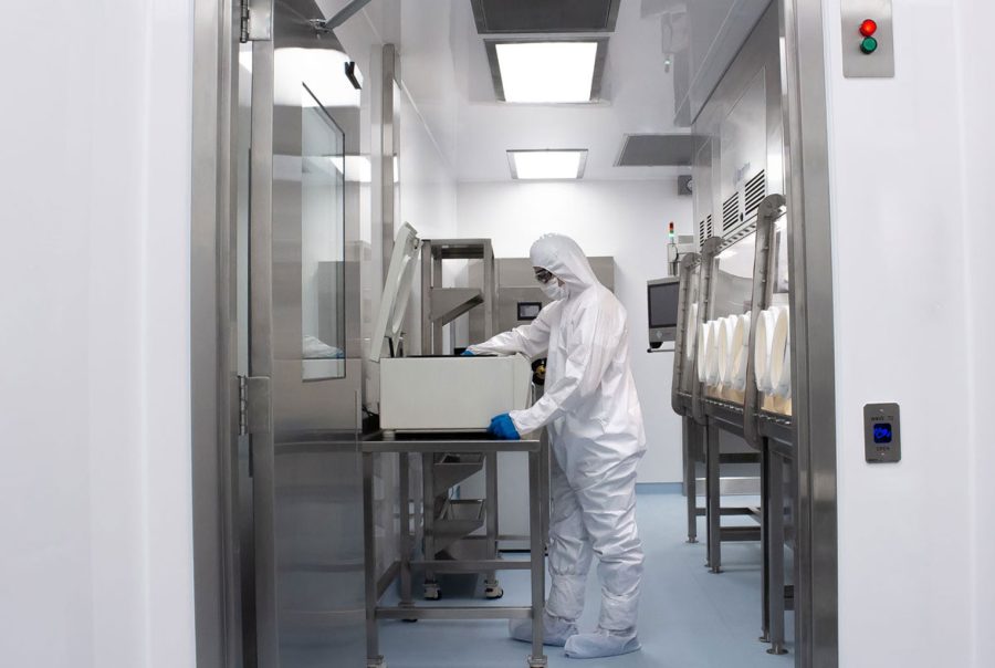 Person working in a cleanroom in biopharma labs