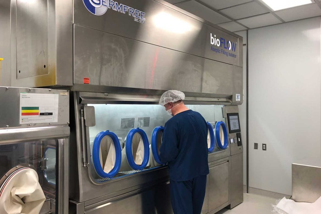 biopharma-custom-isolator-1 Person working at a Custom Isolator