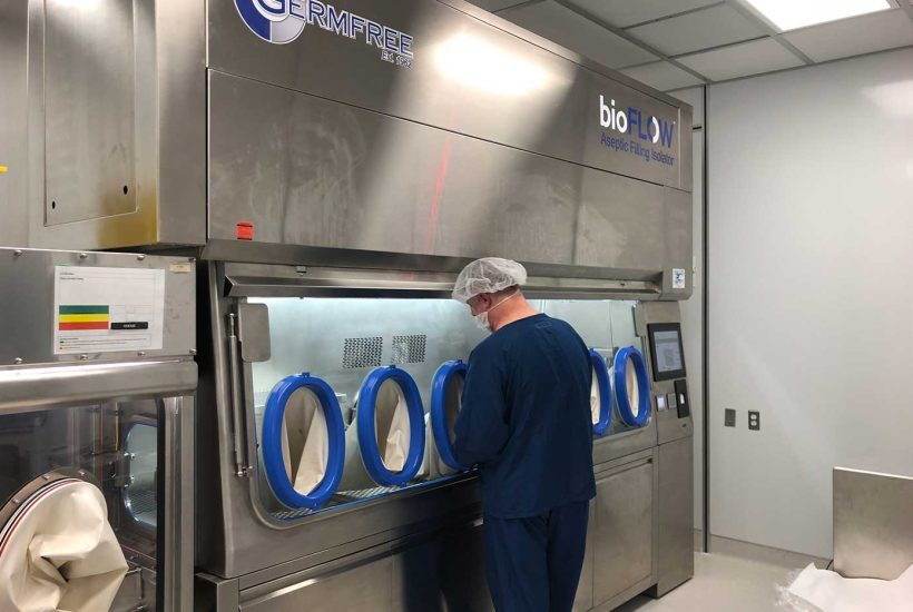 biopharma-custom-isolator-1 Person working at a Custom Isolator