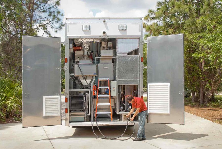 BSL-3 Mobile Laboratory trailer with opened rear and person working