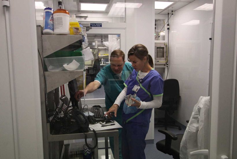 duke-raleigh-mobile-usp-797-800-pharmacy-5 Two people working inside a mobile trailer