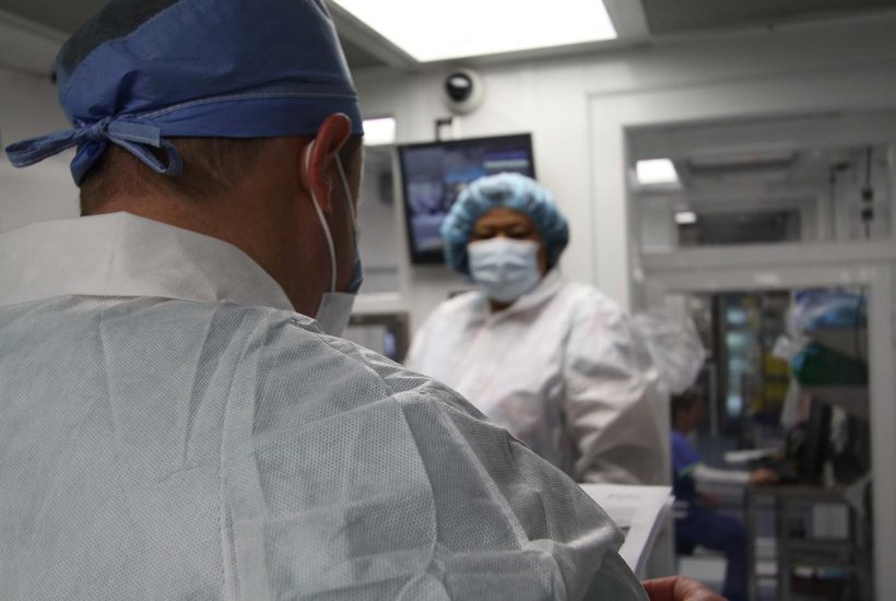 duke-raleigh-mobile-usp-797-800-pharmacy-6 Two people working inside a mobile pharmacy