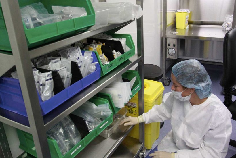 duke-raleigh-mobile-usp-797-800-pharmacy-8 Person taking an item off a shelf