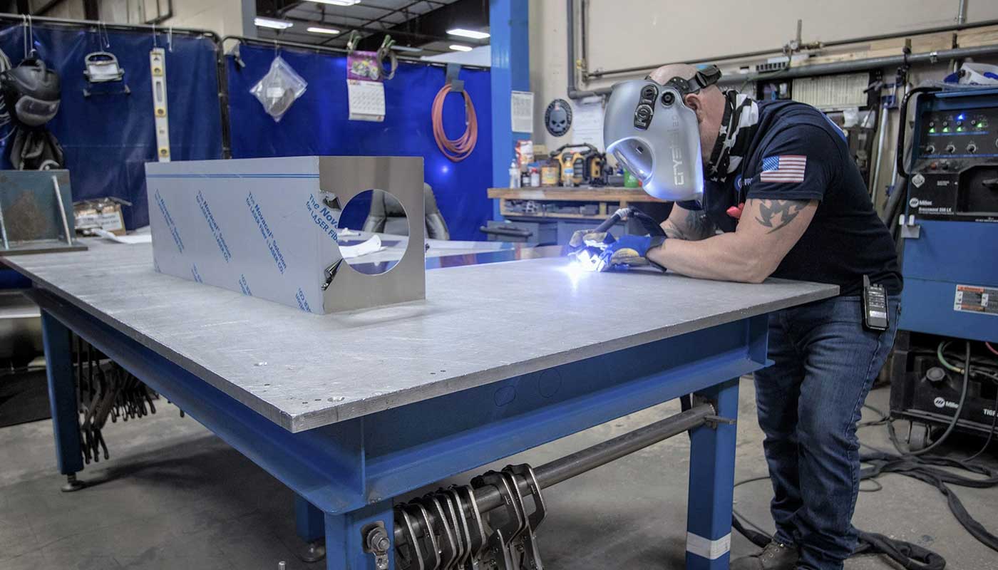 Person welding on a bench
