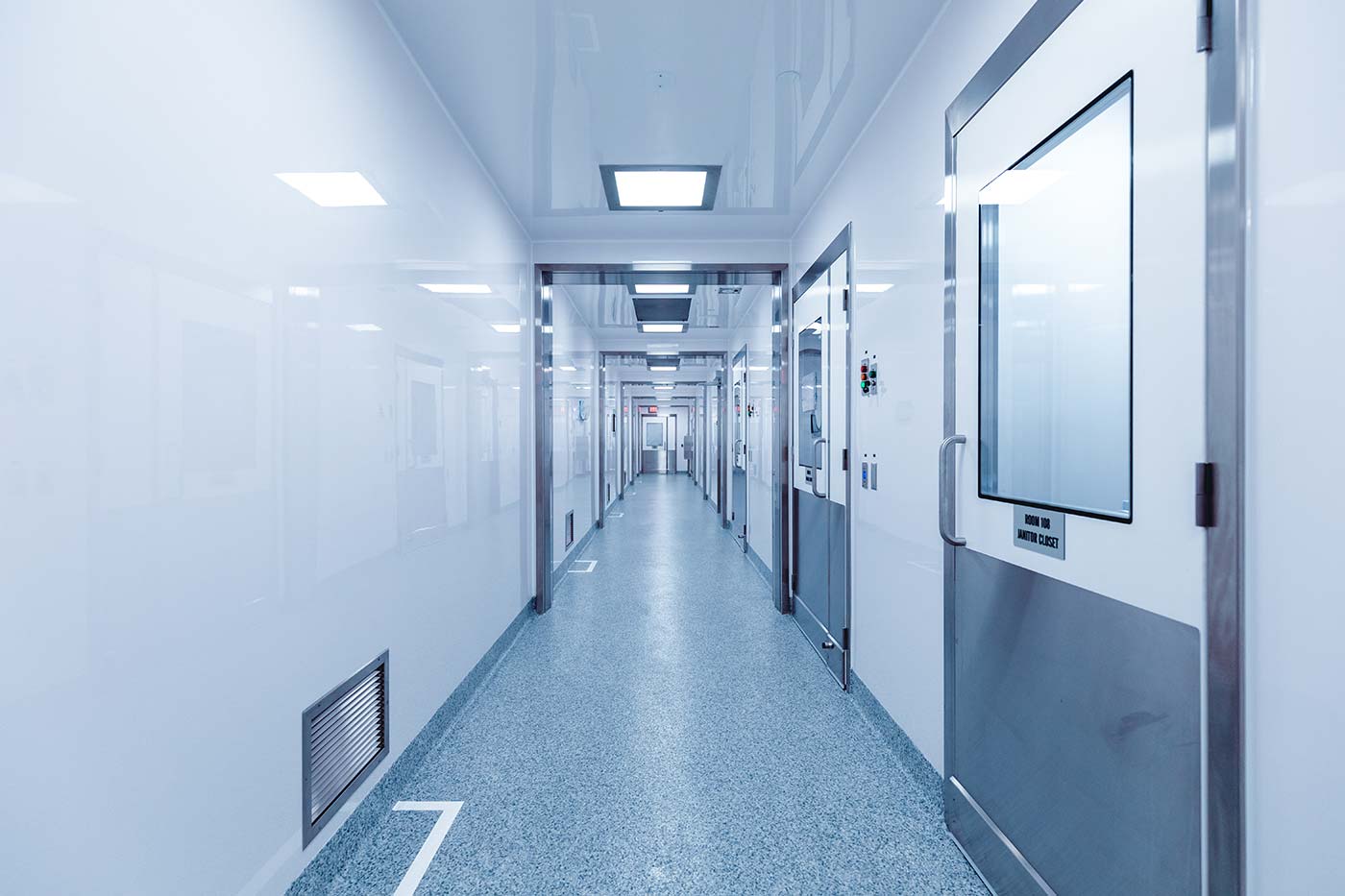 Vibalogics modular BSL-2LS cGMP facility Corridor with wall and vent on the left and multiple doors on the right